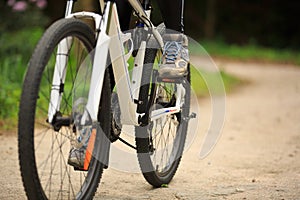 Women cyclist cycling mountain bike on forest trail