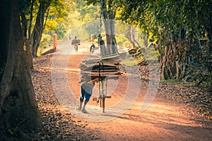 Cyclist on Dirt Road in the jungle. Cambodia