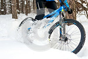 Cyclist Drifting on the Mountain Bike in the Beautiful Winter Forest. Extreme Sport and Enduro Biking Concept.