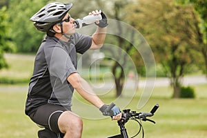 Cyclist drinks water from a bottle