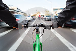 Cyclist drives on the bike path past the traffic jam