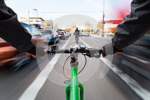 Cyclist drives on the bike path past the traffic jam