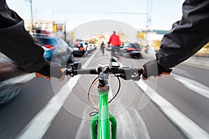 Cyclist drives on the bike path past the traffic jam