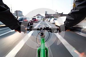 Cyclist drives on the bike path past the traffic jam - First-person view of cyclist