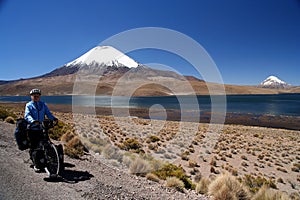 Cyclist in front of Parinacota volcano