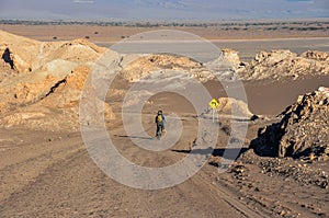 Cyclist going down the Valle de la Luna near San Pedro de Atacama, Chile