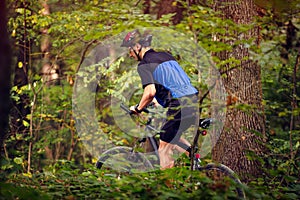 Cyclist in green forest ride bike  .Spring, nature ,sport concept