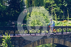Cyclist in helmet riding in park on bridge