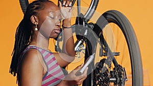 Cyclist hobbyist applying adhesive on bike parts during checkup