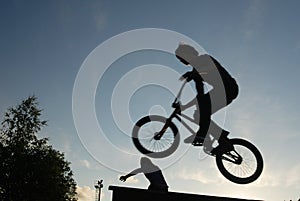 cyclist jumping against the blue sky