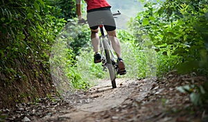 Cyclist legs riding Mountain Bike