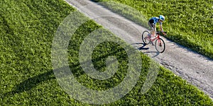 Cyclist with long shadow in a view from above