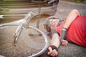 Cyclist lying on the road after hitting by a car