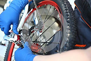 Cyclist man fixing velocipede