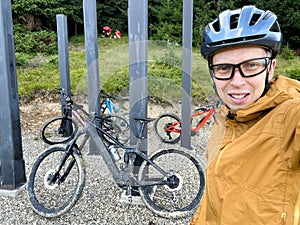 Cyclist man riding electric bike outdoors, enjoying beautiful mountain landscape.