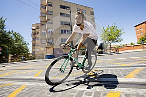 Cyclist man riding fixed gear sport bike.