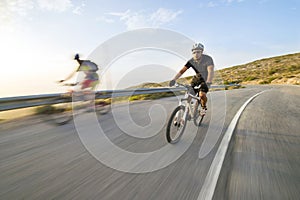 Cyclist man riding mountain bike in sunny day