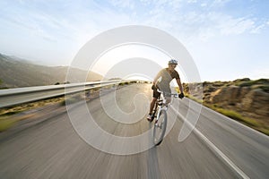 Cyclist man riding mountain bike in sunny day