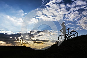 Cyclist man silhouette and mountain bike