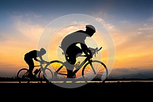 Cyclist in maximum effort in a road outdoors at sunset
