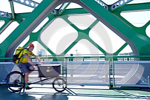 Cyclist in motion on a bridge