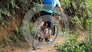 Cyclist With mountain bike on mountain trail