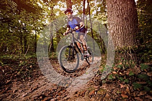 Cyclist on a mountain bike riding in the forest .Spring, nature ,sport concept