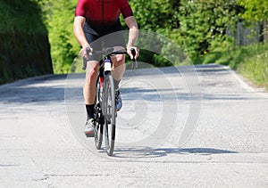 cyclist pedaling on the asphalt road with the racing bike during