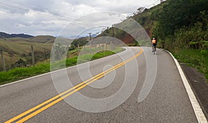 Cyclist pedaling on dual paved road. bike on the road, speed on the bike