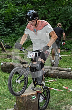 LVIV, UKRAINE - JUNE 2018: A cyclist performs tricks on a bicycle trial to overcome an obstacle course