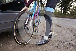 Cyclist preparing his bike for a ride, low section crop