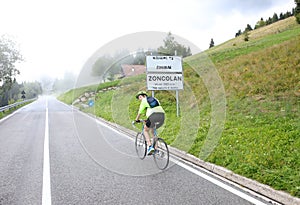 Cyclist with protective helmet pedaling on the uphill road to Mo