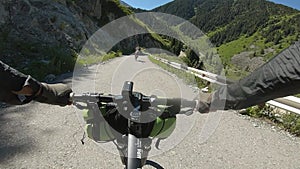 Cyclist ride bicycle at mountain road