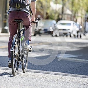 Cyclist rides bicycle on city street friendly to cycling