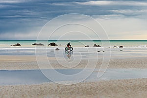Cyclist rides a bike along the Atlantic Ocean