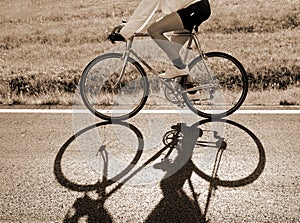 cyclist rides fast against the light with a racing bike on the a