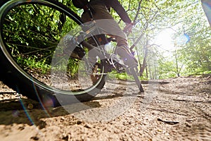 cyclist rides on a forest road. Adventure sport. Mountain bike.