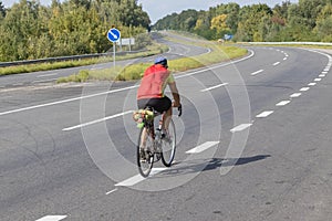 Cyclist rides on the highway on a bicycle