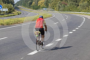 Cyclist rides on the highway on a bicycle