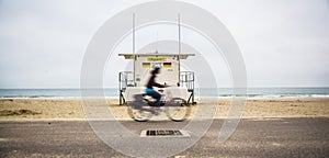 Cyclist Rides passed a Life Guard Station