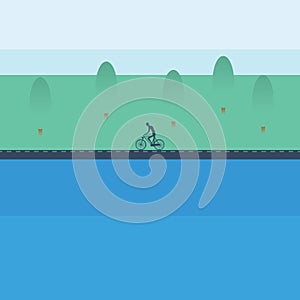 Cyclist riding bicycle near the lake in spring landscape. Healthy active sport lifestyle.