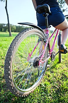 Cyclist riding on bicycle. Rear wide angle view