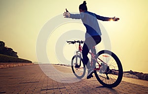 Cyclist riding bike with arms outstretched