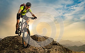 Cyclist Riding the Bike on Autumn Rocky Trail at Sunset. Extreme Sport and Enduro Biking Concept.