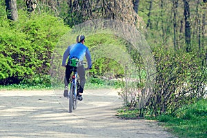 Cyclist riding a bike in a city park