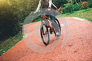 Cyclist riding bike on forest trail