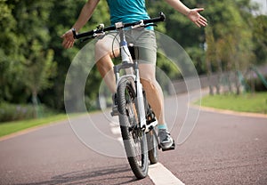 Cyclist riding bike in spring tropical park