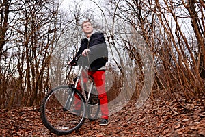 Cyclist Riding the Bike on the Trail in the Beautiful Spring Forest Wide Angle