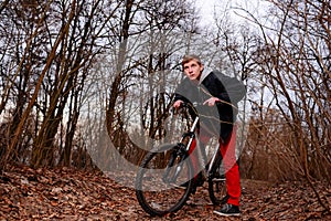 Cyclist Riding the Bike on the Trail in the Beautiful Spring Forest Wide Angle