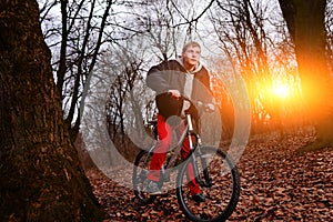 Cyclist Riding the Bike on a Trail in Summer Forest